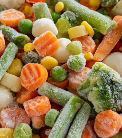 Close-up of mix of frozen vegetables, green peas, broccoli and carrot. Organic food. Top view. Flat lay.